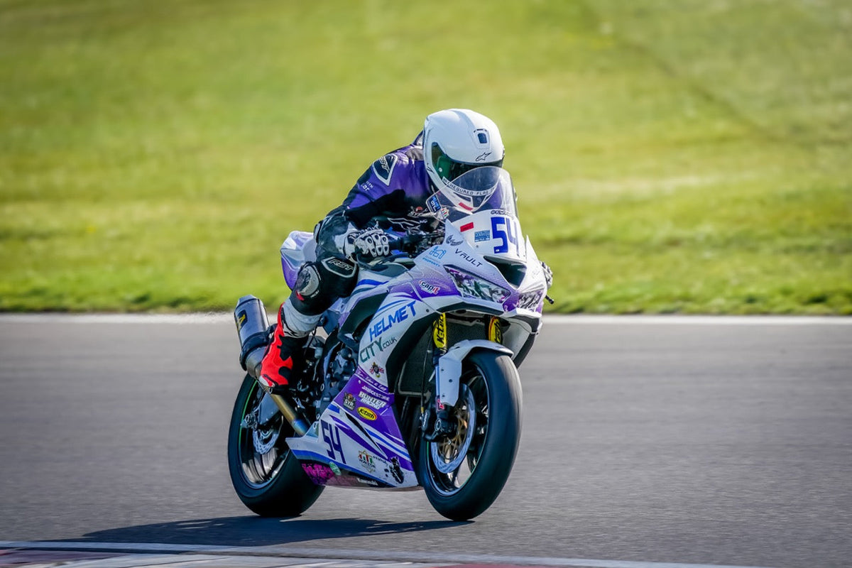 Rider Jake Baldy 54 Anderton battling through the pack aboard his 2020 Kawasaki ZX636 sports bike featuring custom RatMally race graphics at Brands Hatch. Photo by Chequered Flag Images."