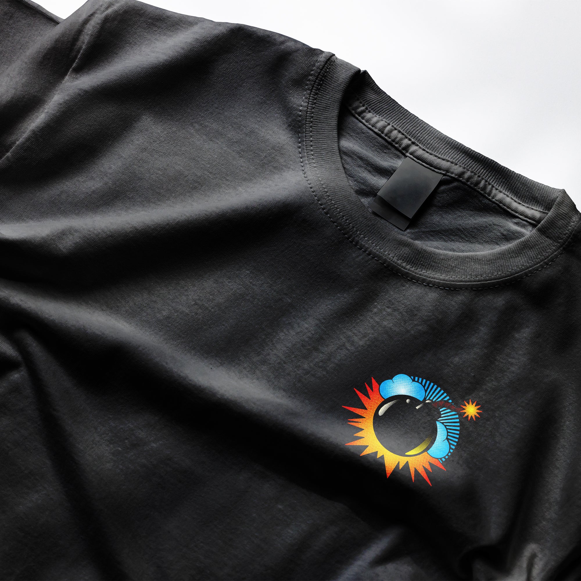 Bomb Tee from Clothing Dioxide. Black t-shirt with a colorful logo on a white background