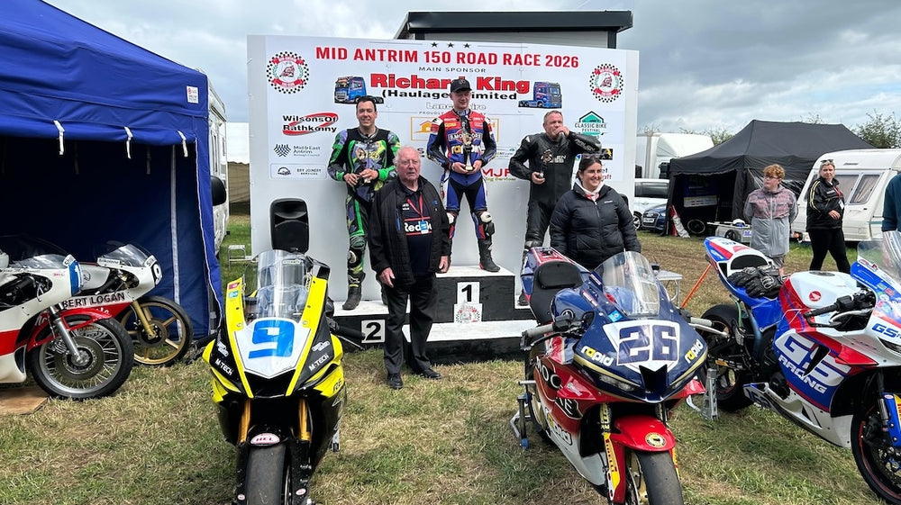 RatMally brand ambassador Nick Round celebrating on the podium with his trophies after finishing second at the Mid Antrim 150 road races.