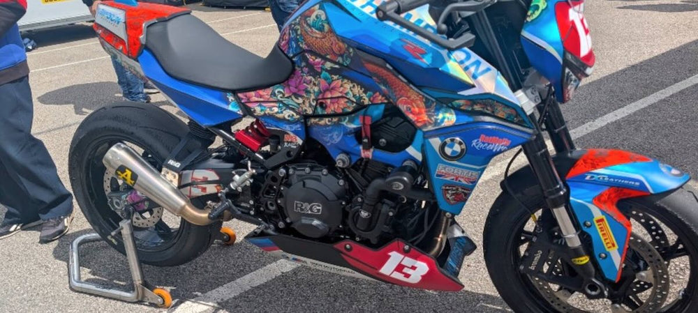 RatMally brand ambassador Andy Booth's BMW F900R Cup motorcycle displaying a fully custom premium RaceWrap livery in the Donington Park paddock